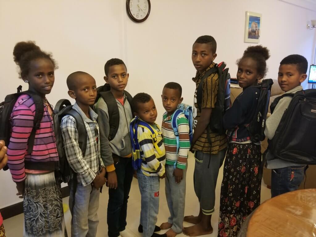 group of kids with backpacks